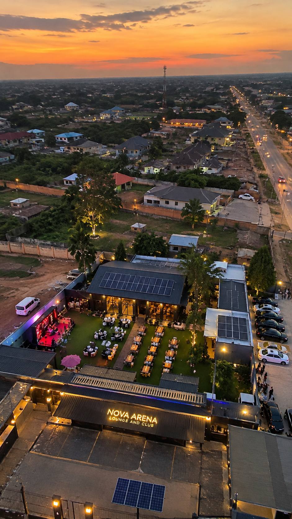 Aerial view of Nova Arena Lounge and Club at dusk, stage lit and courtyard tables set